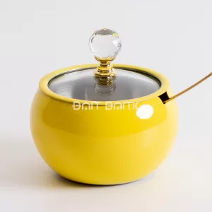 "Yellow glossy sugar jar with crystal knob, gold spoon, and metallic lid — luxury modern serving jar from Bait Baitk."