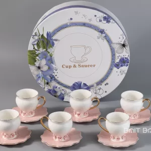 Pink coffee cup and saucer set of six in front of round floral gift box