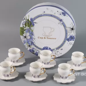 Lavender coffee cup and saucer set of six in front of round floral gift box