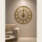 Open frame gold wall clock in a living room