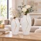 White and gold porcelain vases 30 cm and 26 cm styled together