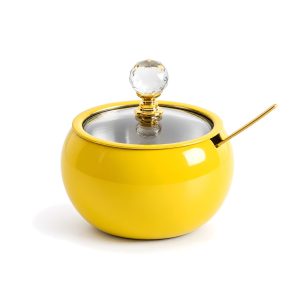 Yellow sugar jar with glass lid on white background