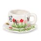 Ceramic cup and saucer with flowers and butterflies