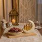 Crescent date set with dates on an iftar table with a lantern